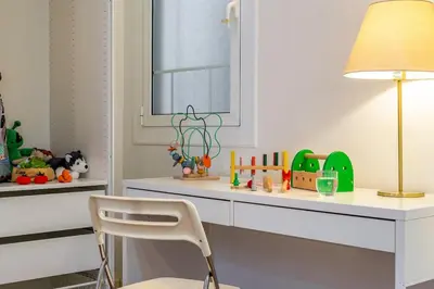 a room with a desk with a chair and a window at Canela Homes BARCELONA GLÒRIES in Barcelona