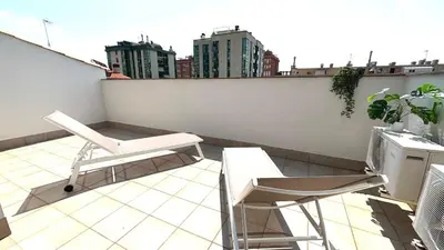 a balcony with a chair and chairs on a roof at Dúplex zona olimpica by Prestigi in Terrassa