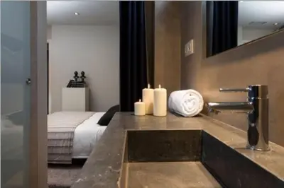 a bathroom with a sink with candles and a bed at Stay Unique Apartment Minerva in Barcelona