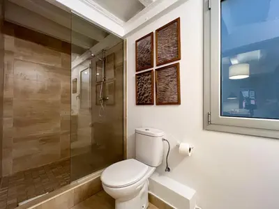 a bathroom with a toilet and a glass shower at Stay Unique Apartment Martínez de la Rosa in Barcelona