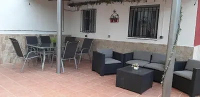 a patio with a table and chairs and a table and a table and chairs at casa vacacional con piscina privada in Sant Cebrià de Vallalta