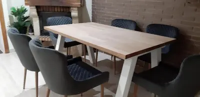a dining room table with chairs and a fireplace at casa vacacional con piscina privada in Sant Cebrià de Vallalta