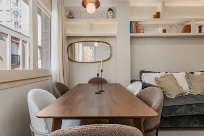 a dining room with a table and chairs and a couch at Bright Apartment in Barcelona in Barcelona