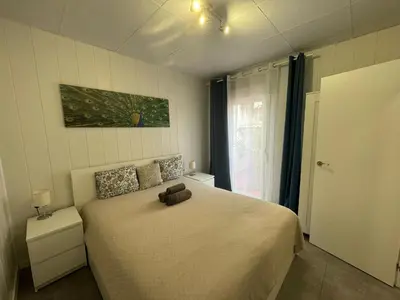 a bedroom with a bed with a teddy bear on it at Sunny Terrace Apartment in Santa Coloma de Gramanet