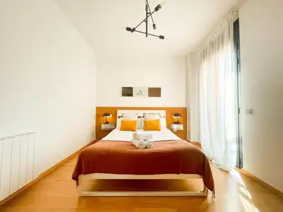a bedroom with a bed with a teddy bear on it at Boutique Socors in Barcelona