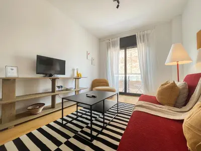 a living room with a couch and a table at Boutique Socors in Barcelona