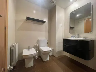 a bathroom with a toilet and a sink and a mirror at Boutique Socors in Barcelona