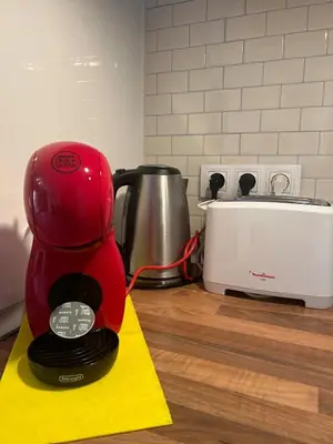 a red coffee maker sitting on a counter in a kitchen at Barceloneta Love 1 min to the beach in Barcelona