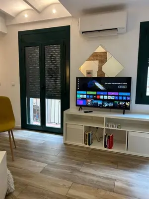 a living room with a large flat screen tv at Barceloneta Love 1 min to the beach in Barcelona