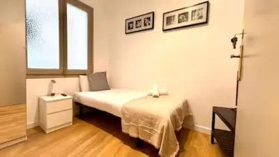 a hallway with white cabinets and a mirror at S4D Villarroel Clinic in Barcelona