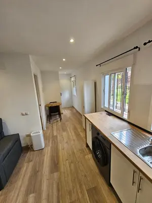 a kitchen and living room with a washer and dryer at Confort House in Argentona