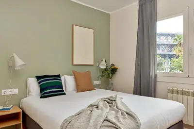 a bedroom with a bed and a window at Casa Cosi - Camp Nou in Barcelona