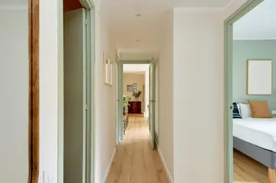 a hallway leading to a bedroom with a bed at Casa Cosi - Camp Nou in Barcelona