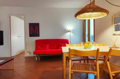 a living room with a red couch and a table at R.G. Central Tranquil 1BR apt. 2BEDS. La Rambla in Barcelona