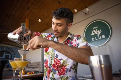 a man making a drink in a martini glass at Urbany Hostel Barcelona in Barcelona