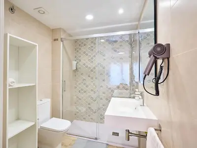 a bathroom with a shower and a toilet and a sink at Tr3sor 11 in Calella