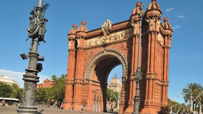 a large brick arch with a statue in front of it at Apartment Park&Beach Deluxe in Barcelona