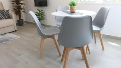 a table and four chairs in a living room at El Barco Aparta Hotel in Hospitalet de Llobregat