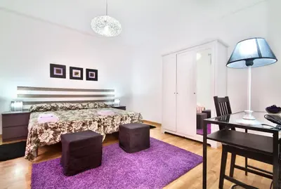 a bedroom with a bed and a purple rug at Apartment Gaudi XL in Barcelona