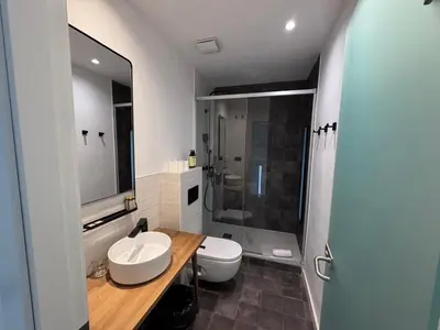 a bathroom with a sink and a toilet and a shower at Vaganto Coliving in Barcelona