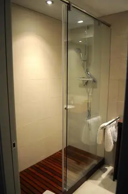 a shower with a glass door in a bathroom at Ático con vistas al mar, solarium privado y piscina in Sitges