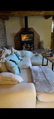 a group of pillows in a room with a fireplace at Roca negra Montseny in Fogars de Montclus