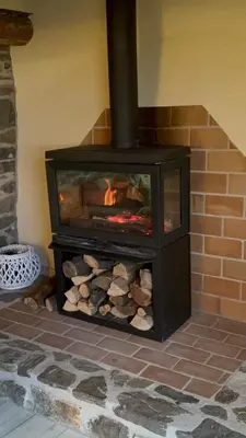 a brick oven with a fire inside of it at Roca negra Montseny in Fogars de Montclus