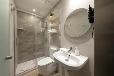 a bathroom with a toilet and a sink and a shower at Standbyme Ramblas in Barcelona