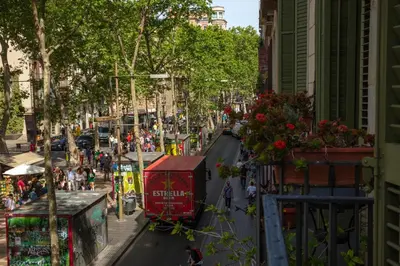 a street in a city with a red tram at Standbyme Ramblas in Barcelona