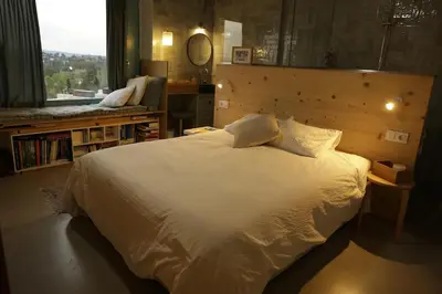 a bedroom with a large white bed and a window at Independent duplex in a stately villa in Sant Cugat del Vallès