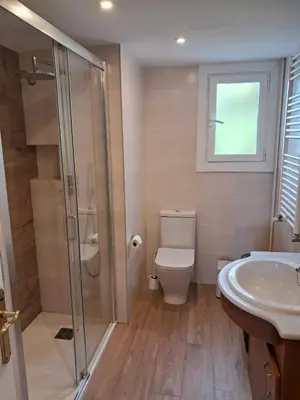 a bathroom with a shower and a toilet and a sink at Quiet cozy apartment near beach in Sitges