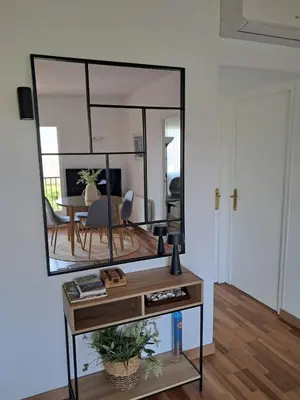 a mirror on a table in a living room at Quiet cozy apartment near beach in Sitges