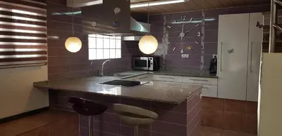 a kitchen with a counter with a sink and a microwave at Tranquilidad y Privacidad in Cánoves