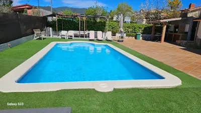 a large blue swimming pool in a yard at Tranquilidad y Privacidad in Cánoves