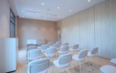 a room with rows of chairs and a whiteboard at Holiday Inn Express & Suites Barcelona - Sabadell by IHG in Sabadell