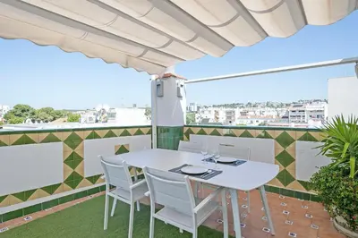 a white table and chairs on a balcony at Beach Penthouse in Sitges