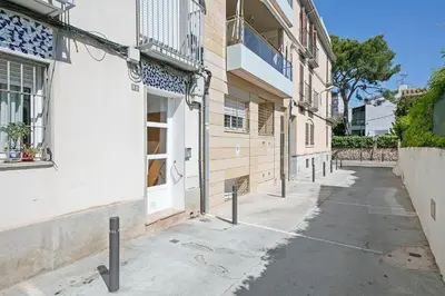 an alleyway between two buildings in a city at Beach Penthouse in Sitges