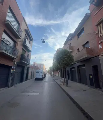 a van parked on a street between two buildings at D&G casas in El Prat de Llobregat