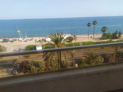 a balcony with a view of the beach and the ocean at Precioso apartamento en primera linea de mar Beautiful apartment on the first line of the sea in Pineda de Mar