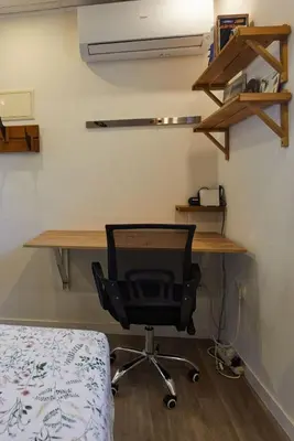 a desk and a chair in a room with a bed at Casa en Sierra Collserola in Sant Cugat del Vallès