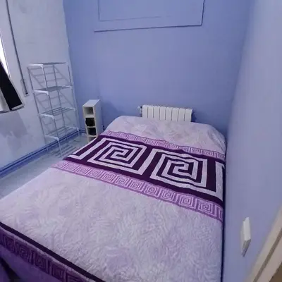 a small bedroom with a bed in a room at Habitación azul con cama doble disponible en Barcelona in Barcelona
