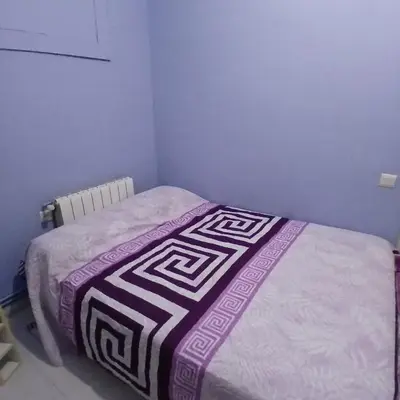 a bedroom with a bed with a blanket on it at Habitación azul con cama doble disponible en Barcelona in Barcelona