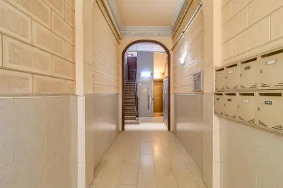an empty hallway in a building with lockers and a door at GuestReady- Lovely apartment in Barcelona in Barcelona