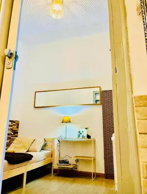 a living room with a bed and a mirror at Basic interior Apartment Sagrada Familia Excellent for exploring Barcelona Very good location in Barcelona