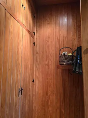 a room with wooden cabinets and a basket on a shelf at Can Marisu, Casita privada in Cabrils