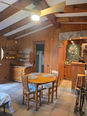 a kitchen with a wooden table and chairs at Can Marisu, Casita privada in Cabrils