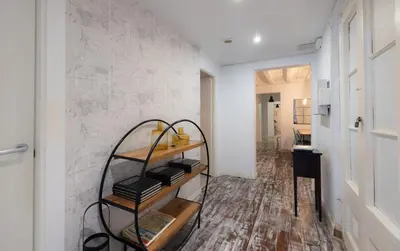 a room with a shelf with books on a wall at Stay U-nique Roger Llúria in Barcelona