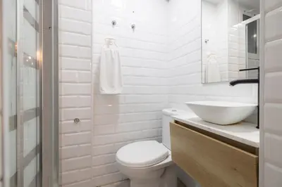 a white bathroom with a toilet and a sink at Stay U-nique Roger Llúria in Barcelona