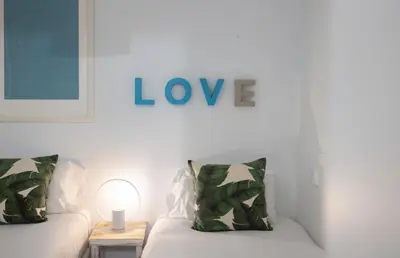 a living room with a couch and a sign that reads love at Stay U-nique Roger Llúria in Barcelona