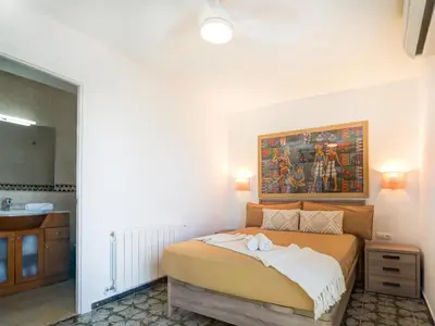 a bedroom with a bed and a painting on the wall at Horizon Views by Hello Homes Sitges in Sitges